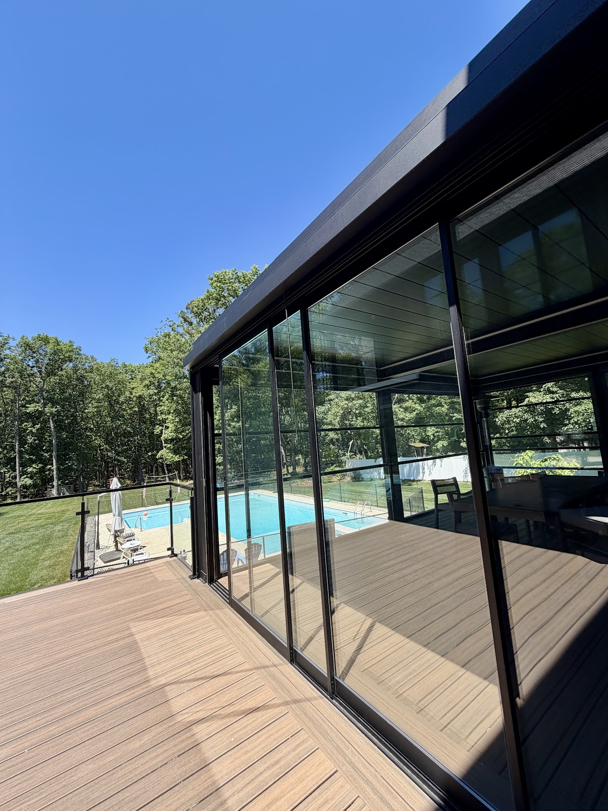 Pool-side pergola with glass walls